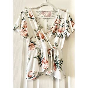 Caution to the Wind White and floral top fits like a M